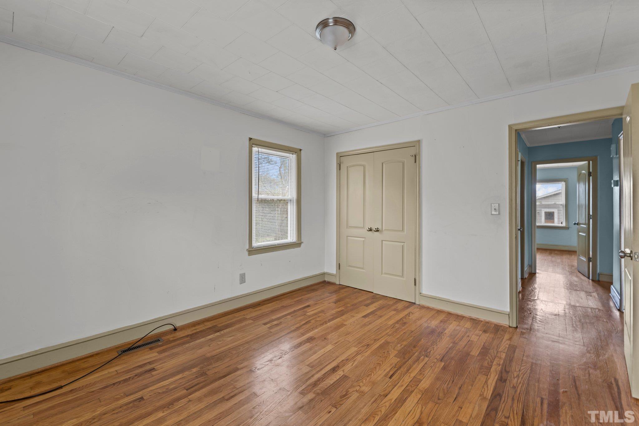 293 Cavel Chub Lake Road Roxboro, NC 27574 - Photo 13 of 15 wooden floor in an empty room with a window