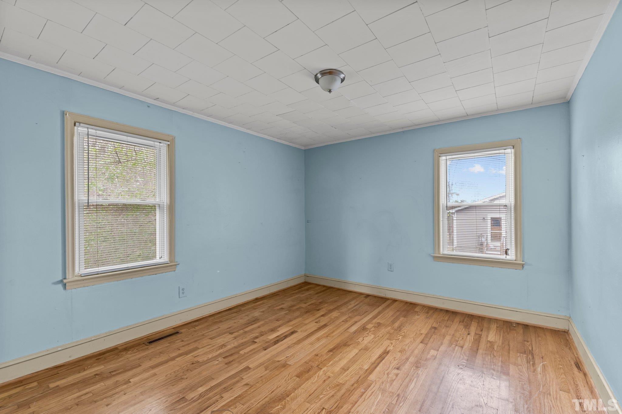 293 Cavel Chub Lake Road Roxboro, NC 27574 - Photo 15 of 15 a view of an empty room with wooden floor and a window