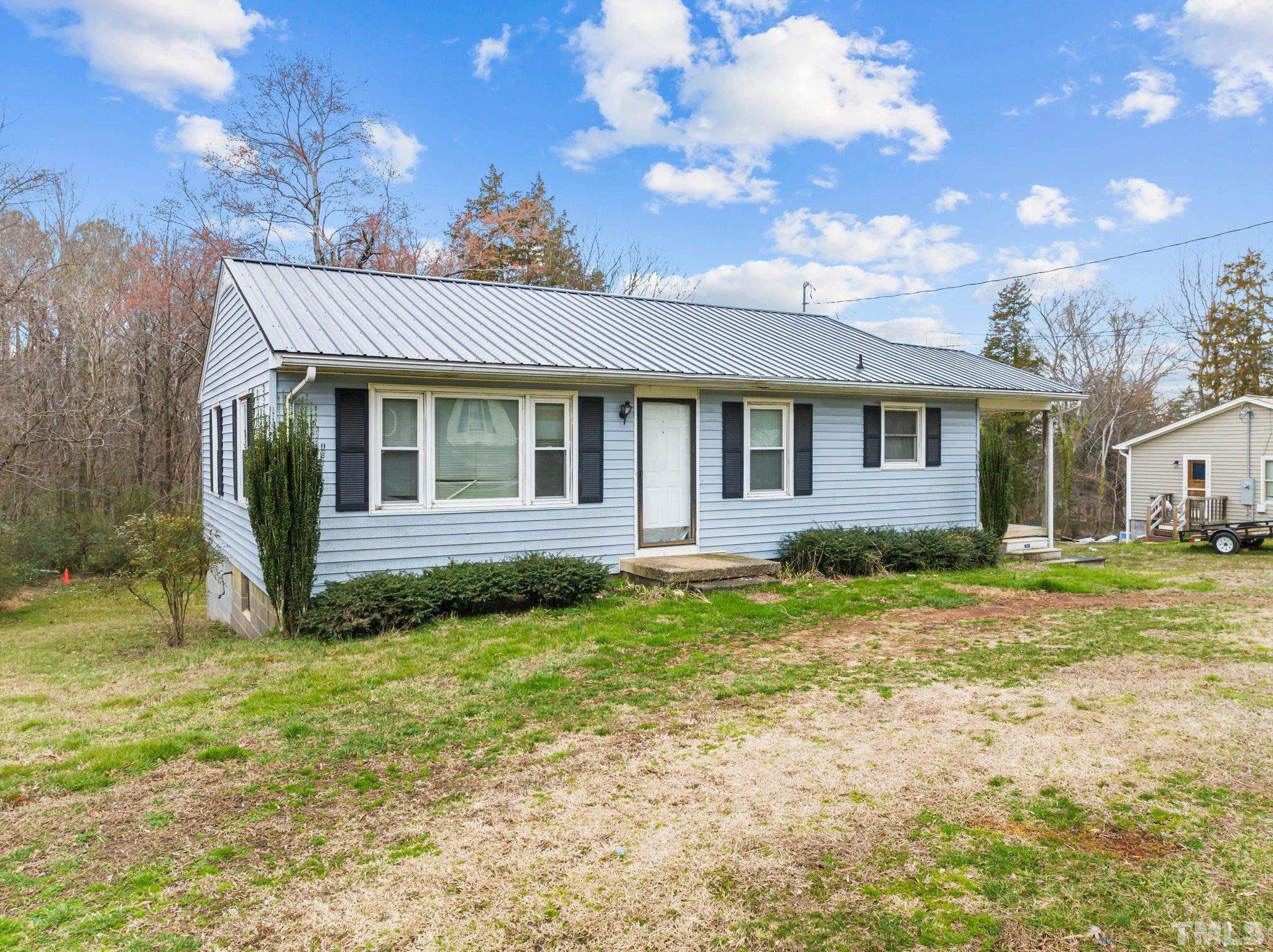 293 Cavel Chub Lake Road Roxboro, NC 27574 - Photo 2 of 15 a view of a house with backyard and sitting area
