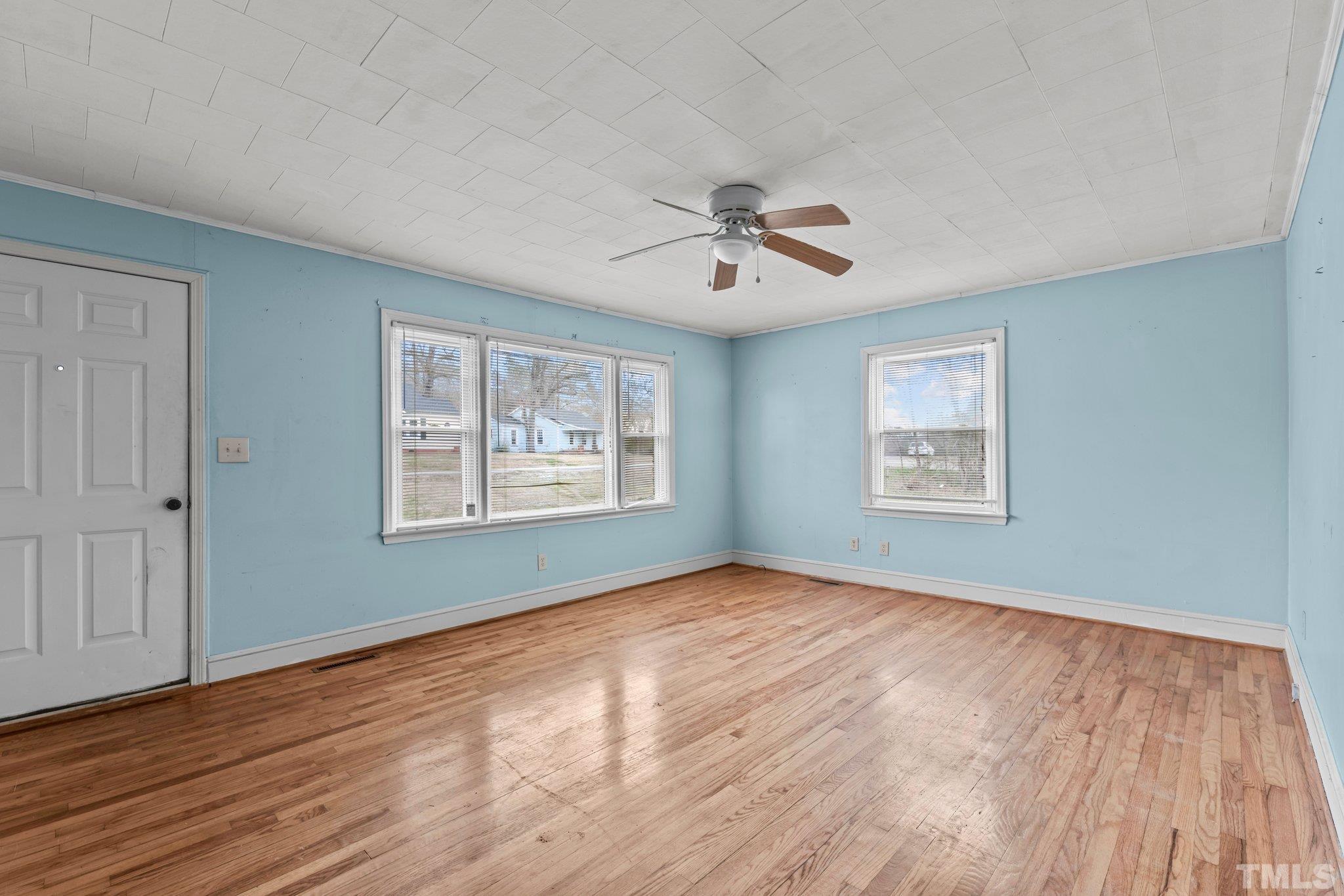 293 Cavel Chub Lake Road Roxboro, NC 27574 - Photo 4 of 15 a view of an empty room with a window and wooden floor