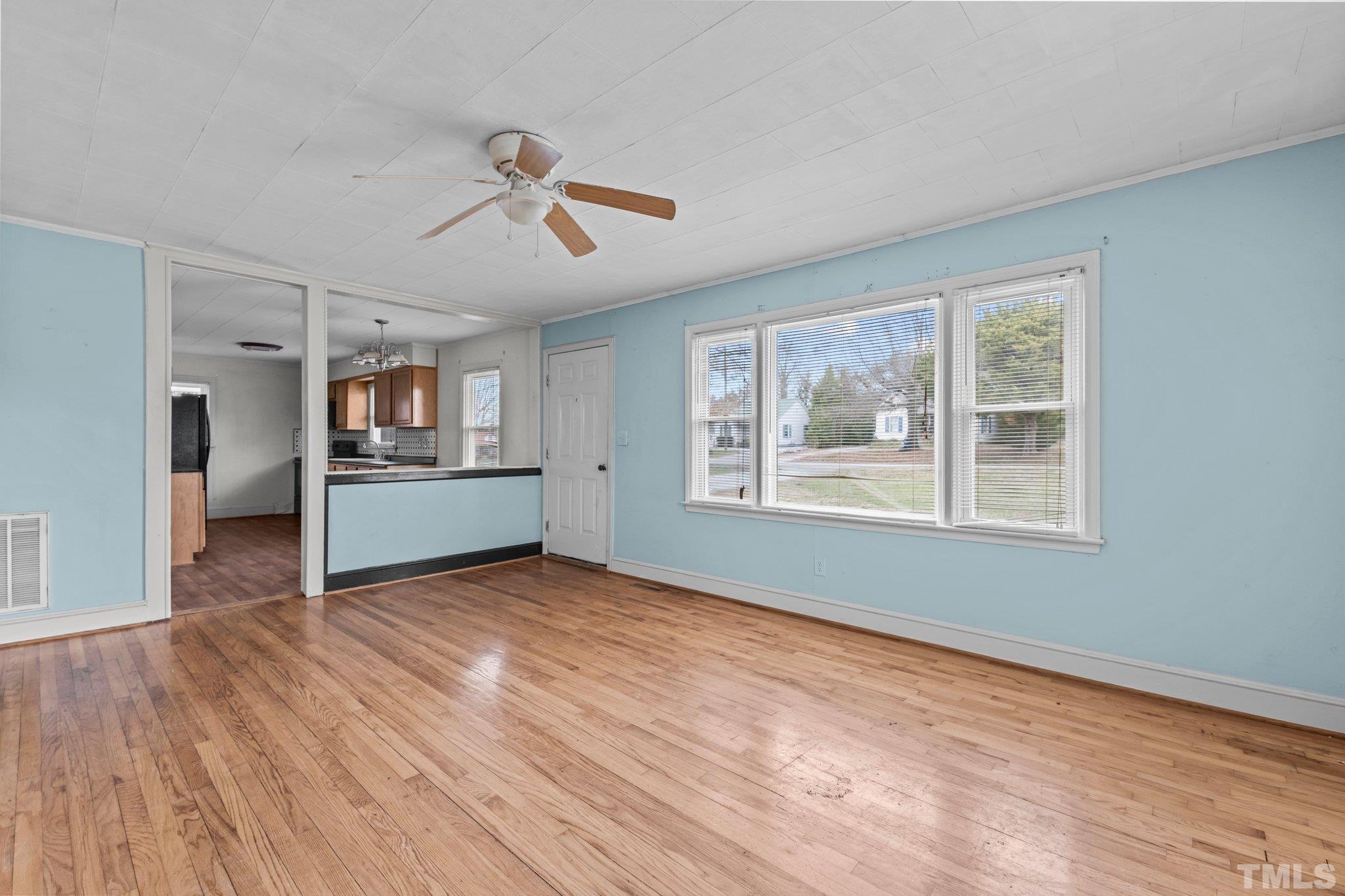 293 Cavel Chub Lake Road Roxboro, NC 27574 - Photo 5 of 15 a view of an empty room with a window and wooden floor