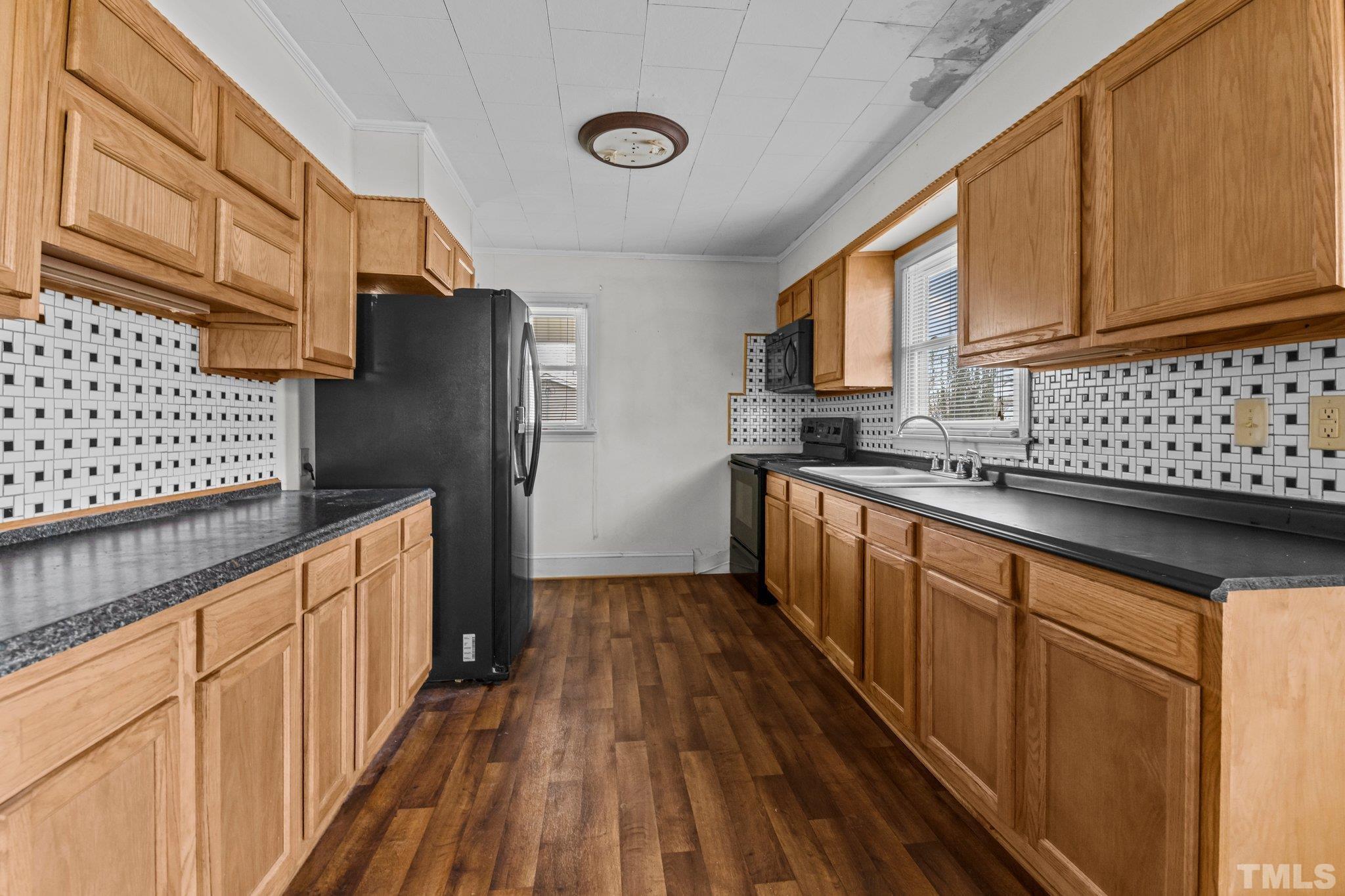 293 Cavel Chub Lake Road Roxboro, NC 27574 - Photo 7 of 15 a kitchen with stainless steel appliances a sink and a refrigerator