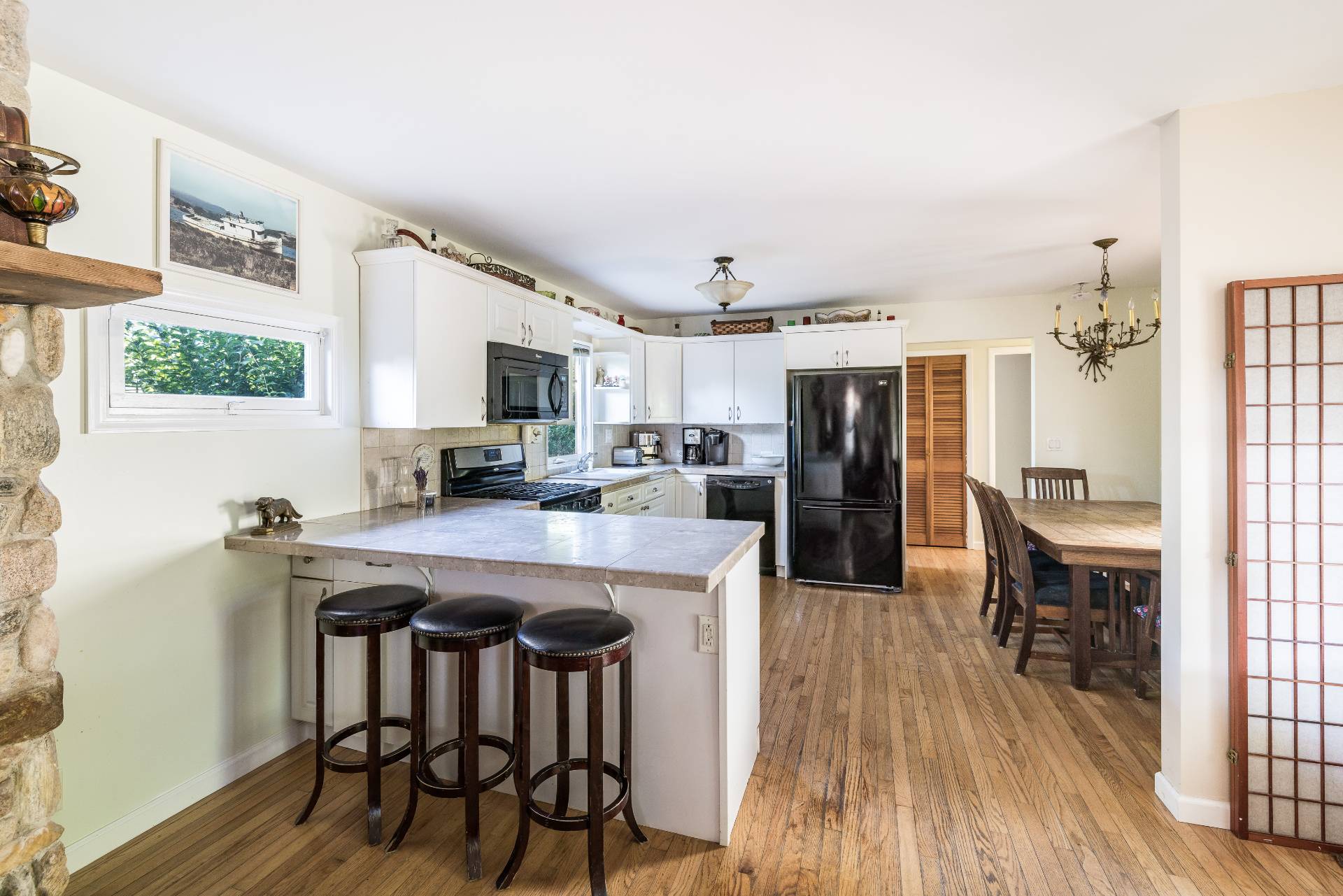 9 Ditch Plains Road Montauk, NY 11954 - Photo 4 of 14 a kitchen with stainless steel appliances granite countertop a table chairs and a refrigerator