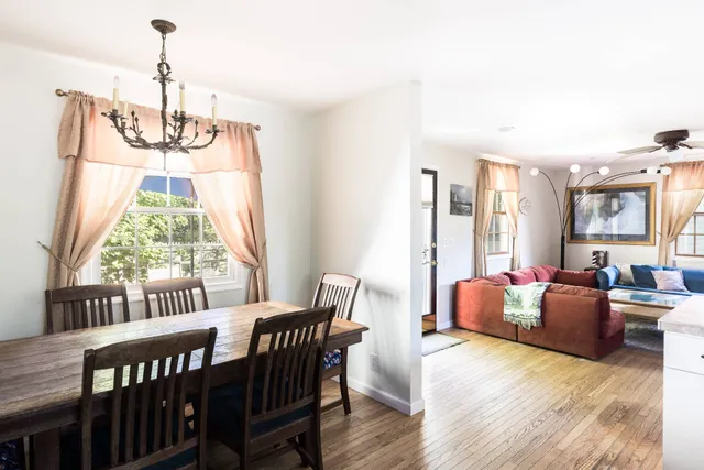 a view of a dining room with furniture window and wooden floor