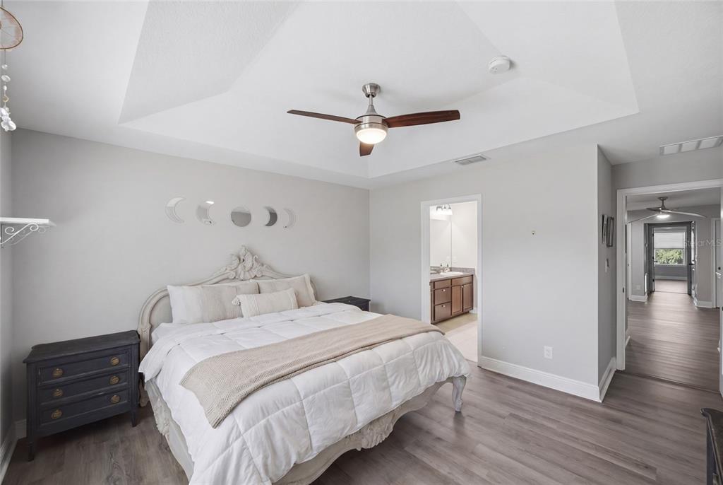 2013 Sunset Wind Loop Oldsmar, FL 34677 - Photo 16 of 43 a bedroom with a bed and wooden floor