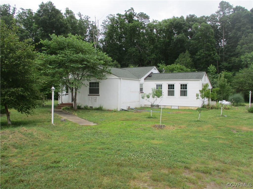 2409 Burgess Road Chester, VA 23836 - Photo 2 of 50 a house with a big yard and large trees