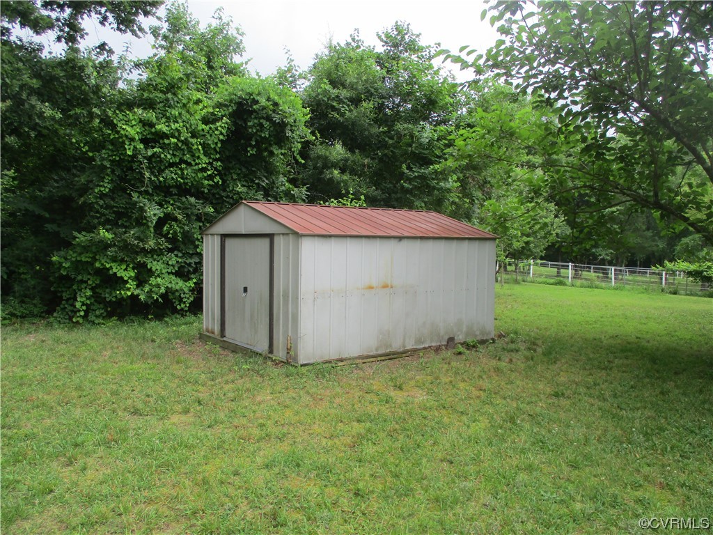 2409 Burgess Road Chester, VA 23836 - Photo 9 of 50 a backyard of a house with plants and large trees