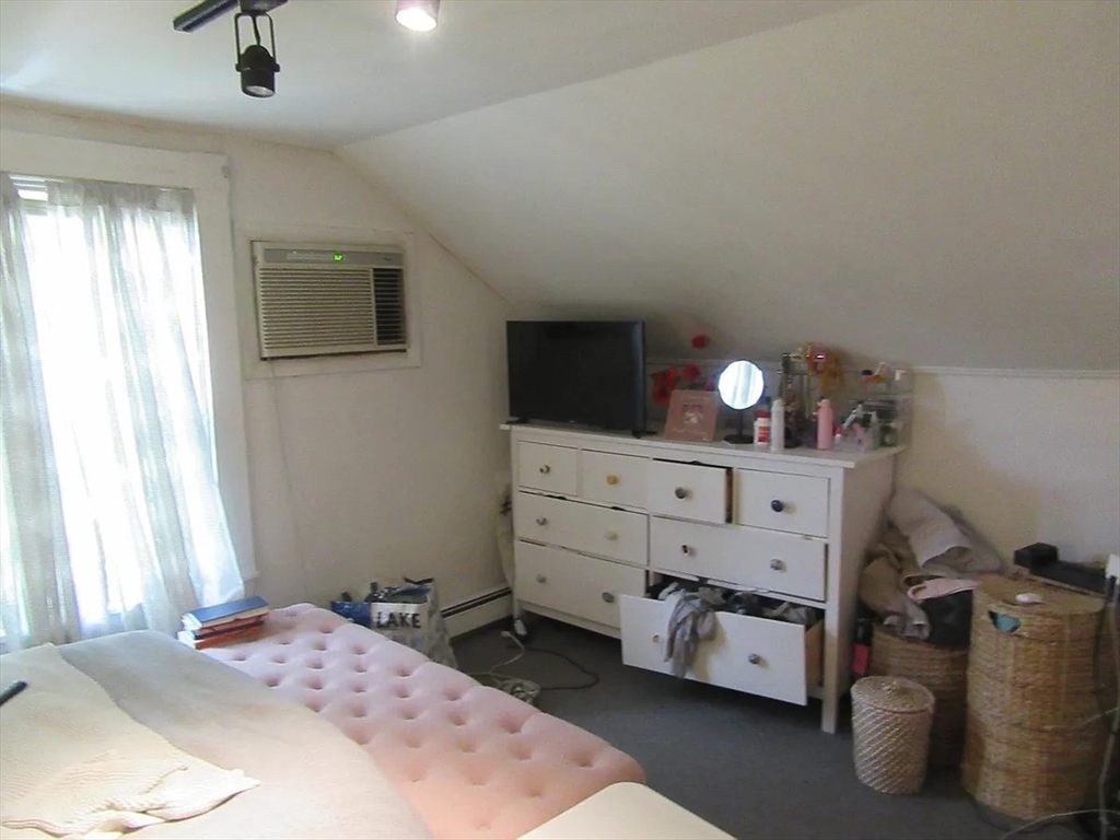 18 Tremont Street, Unit 2 Cambridge, MA 02139 - Photo 11 of 14 a bed room with a bed and a tv