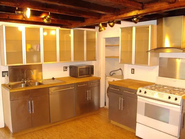 a kitchen with stainless steel appliances granite countertop a stove and a sink