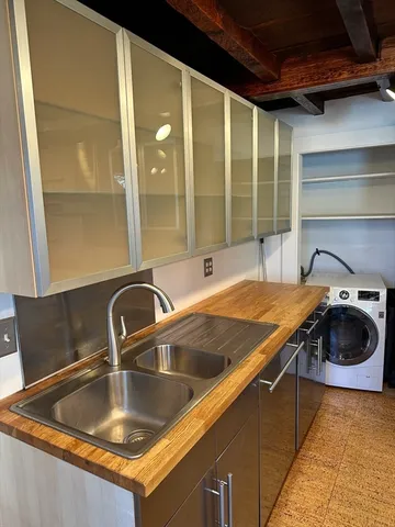 a kitchen with a sink and a cabinet with a granite countertops