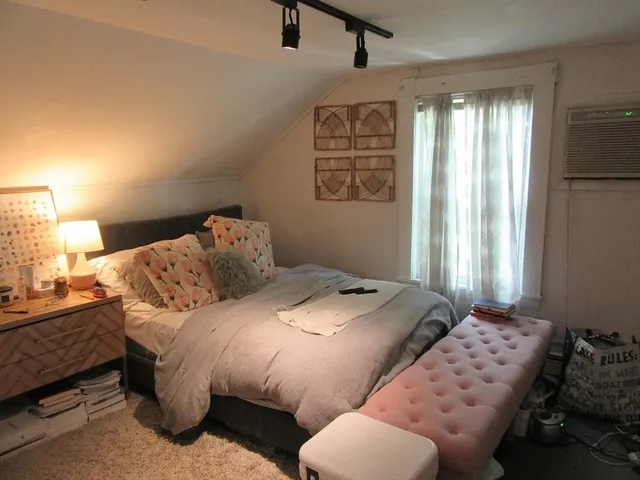 a bedroom with bed and window