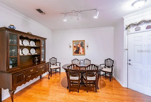 a view of a dining room with furniture and a kitchen