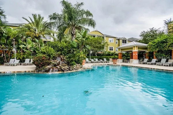 a view of swimming pool with outdoor seating and lake view