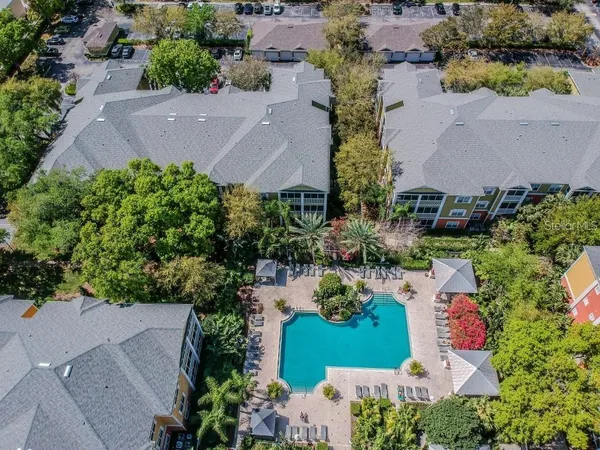 an aerial view of a house with a garden and swimming pool