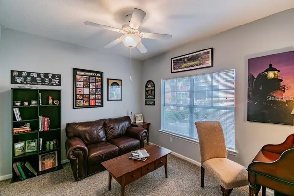 a living room with furniture a lamp and a window
