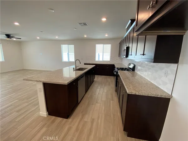 a kitchen with a sink a counter top space and a window