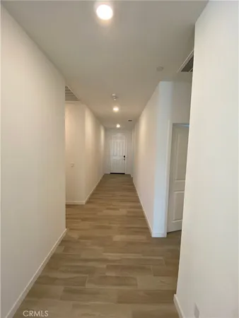 a view of hallway with wooden floor