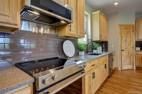 a kitchen with wooden cabinets and a stove top oven