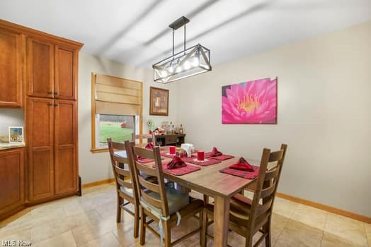 4618 South Arlington Road Uniontown, OH 44685 - Photo 8 of 31 Tiled dining room with a notable chandelier