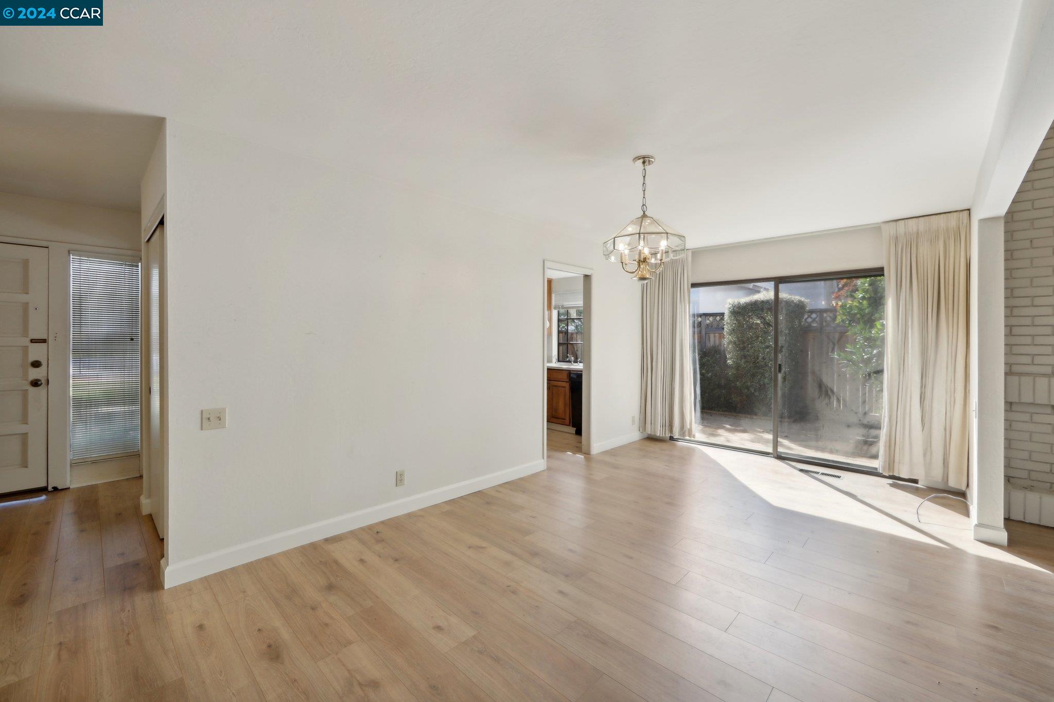 826 Augusta Drive Moraga, CA 94556 - Photo 13 of 35 an empty room with wooden floor wooden floor and windows