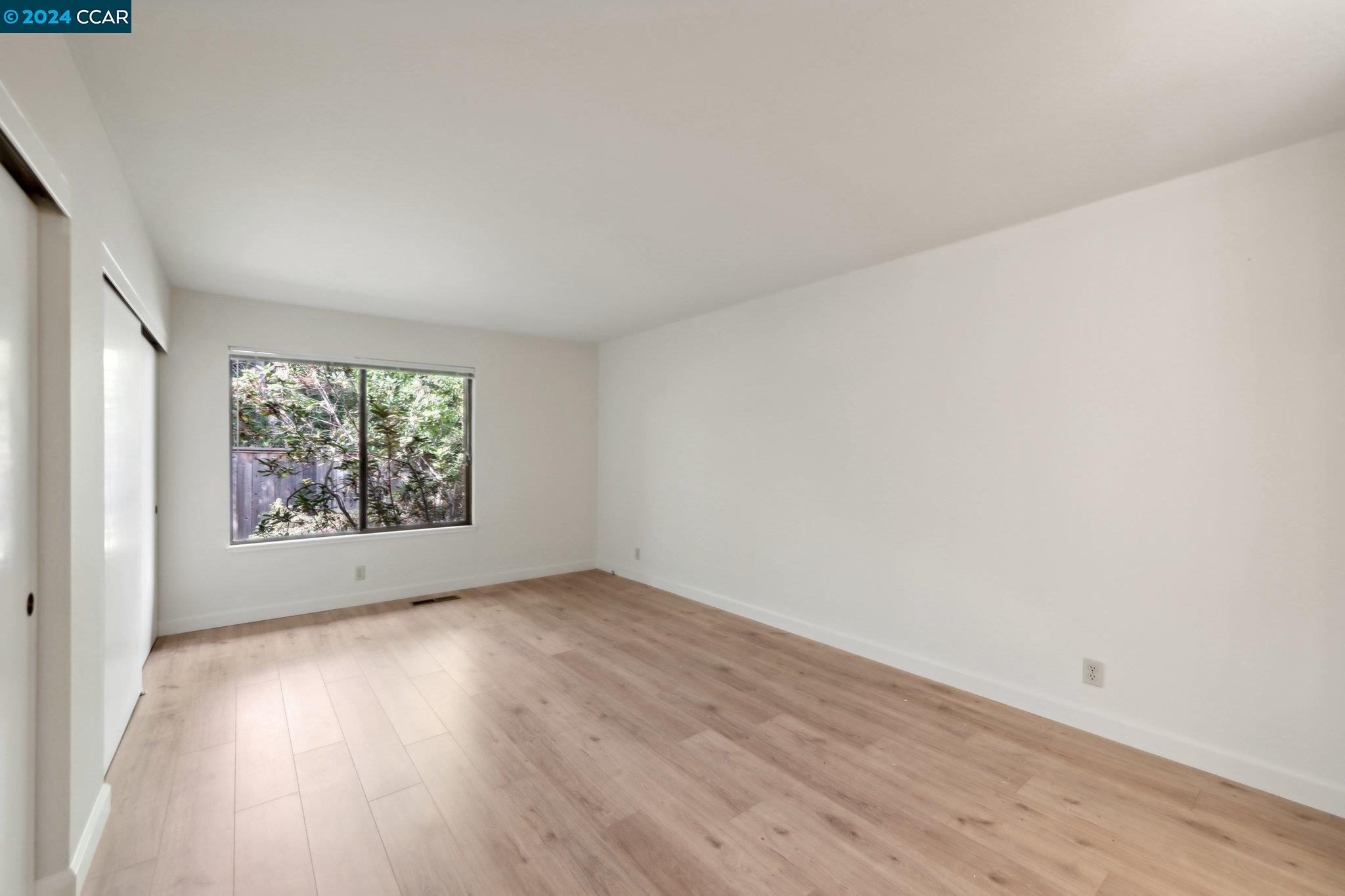 826 Augusta Drive Moraga, CA 94556 - Photo 18 of 35 an empty room with wooden floor and windows