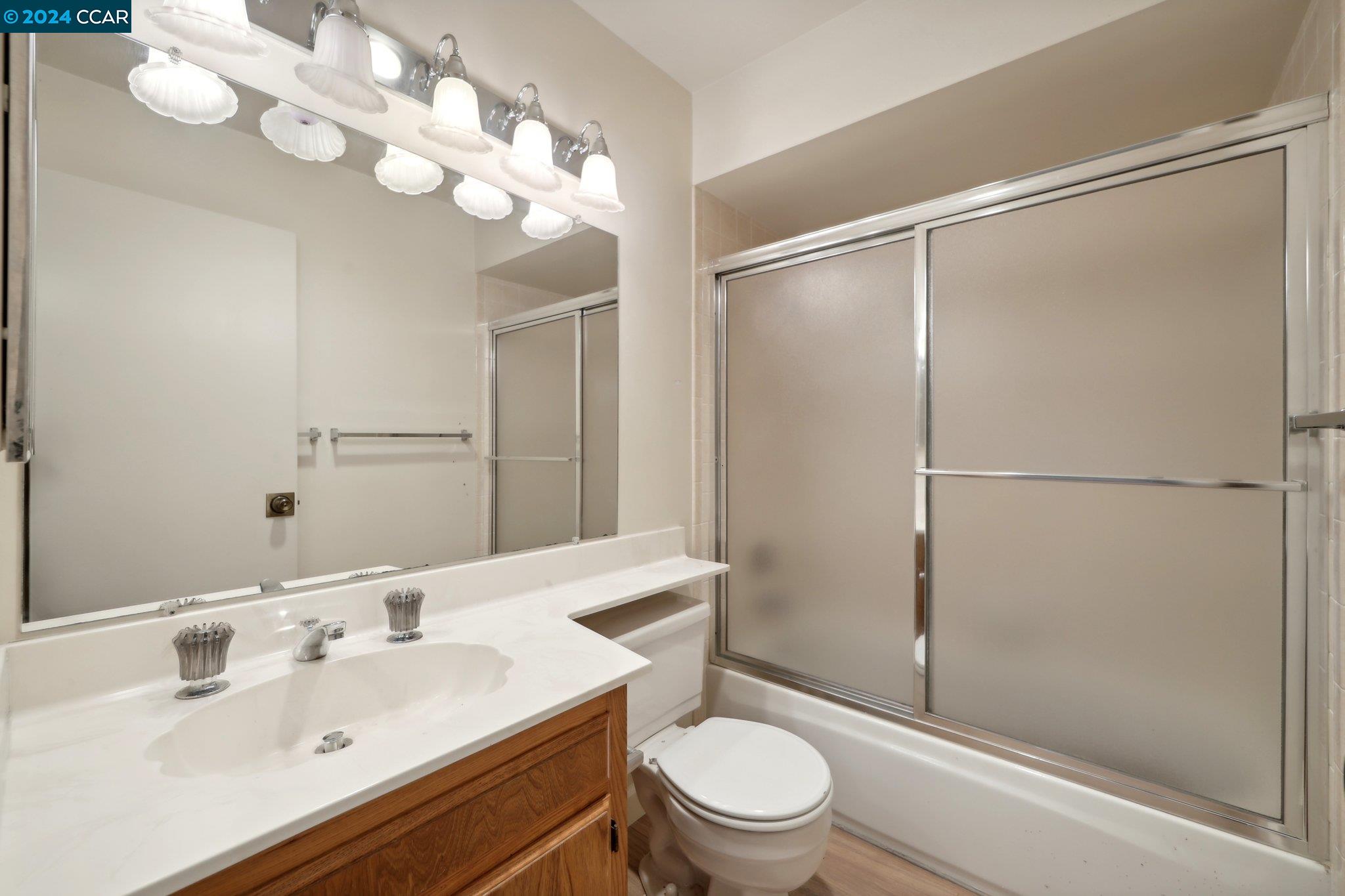 826 Augusta Drive Moraga, CA 94556 - Photo 25 of 35 a bathroom with a sink toilet mirror and shower