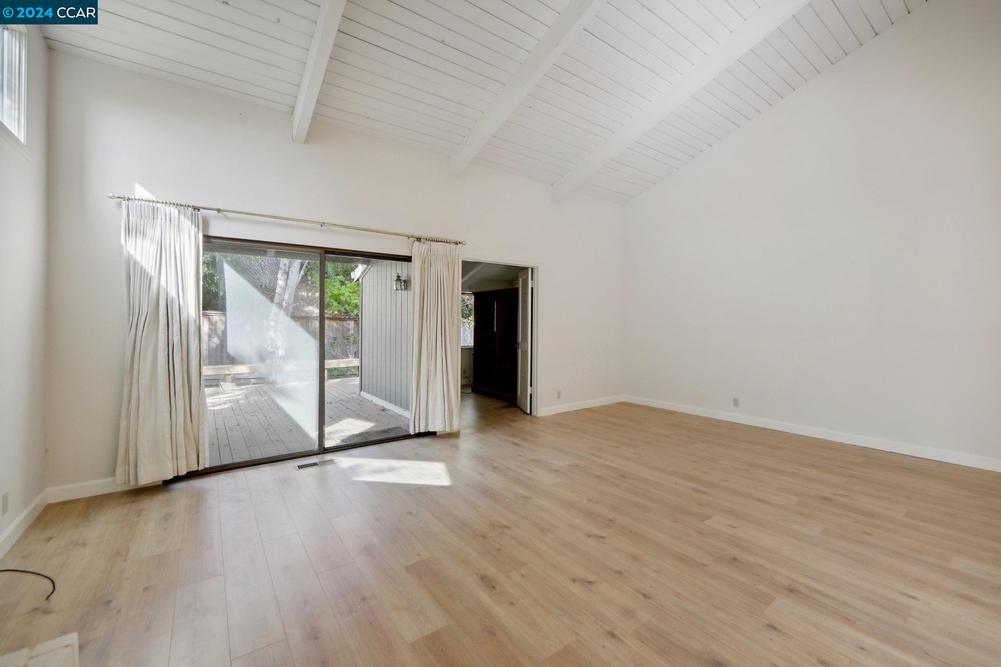826 Augusta Drive Moraga, CA 94556 - Photo 10 of 35 an empty room with wooden floor and windows