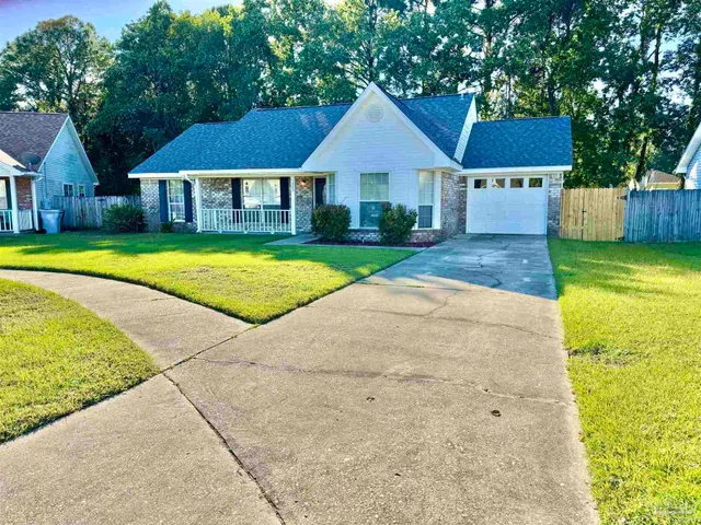 a front view of a house with yard and green space