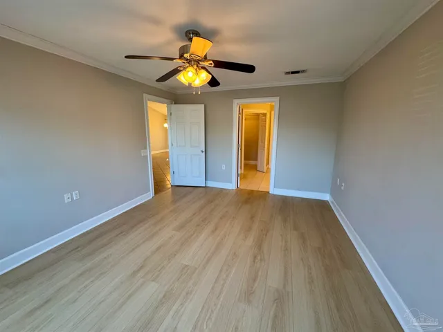 a view of an empty room and wooden floor