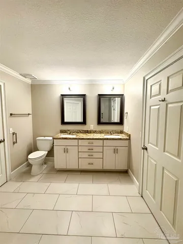 a bathroom with a double vanity sink mirror and toilet