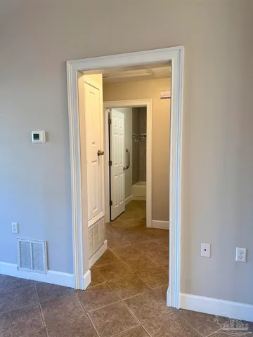 a view of a bathroom with a glass door and a table