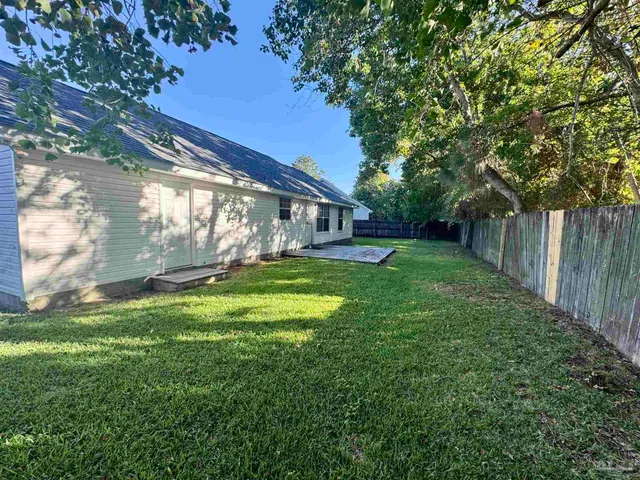 a view of house with backyard