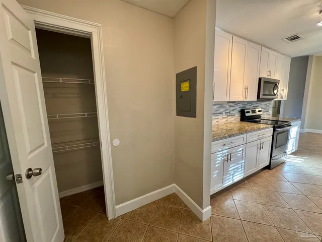 a kitchen with stainless steel appliances a refrigerator and a stove top oven