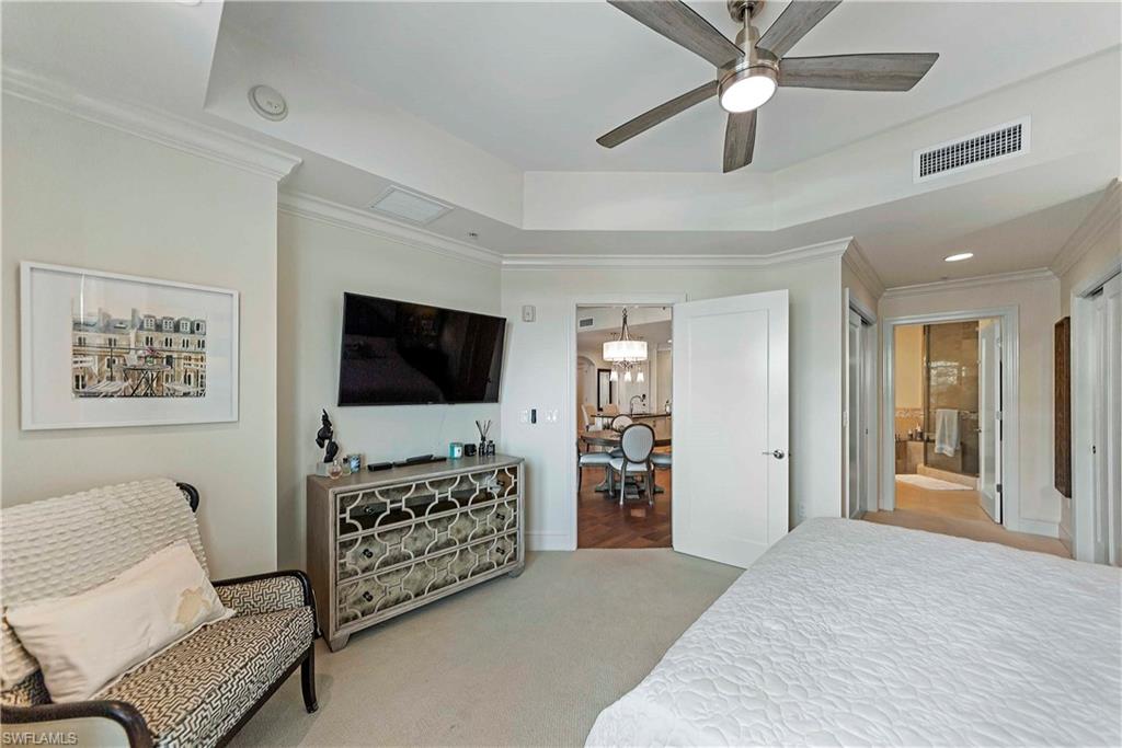 9115 Strada Place, Unit 5501 Naples, FL 34108 - Photo 11 of 31 a living room with furniture and a flat screen tv