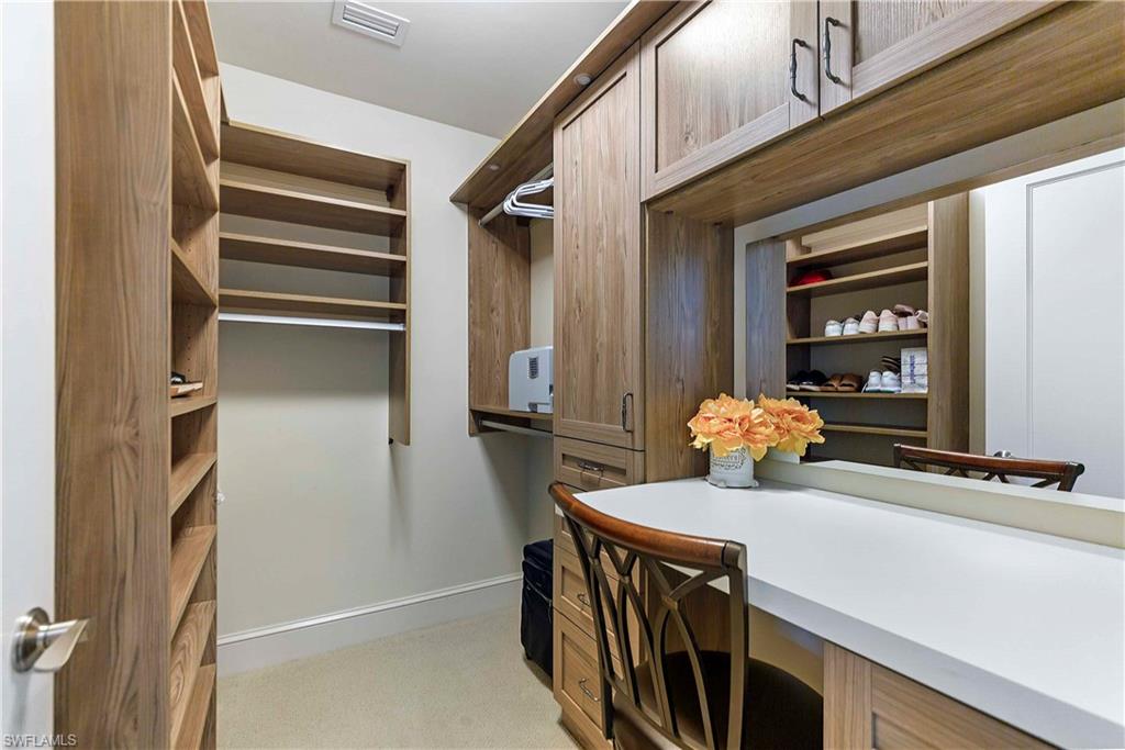 9115 Strada Place, Unit 5501 Naples, FL 34108 - Photo 14 of 31 a view of a hallway with wooden cabinet
