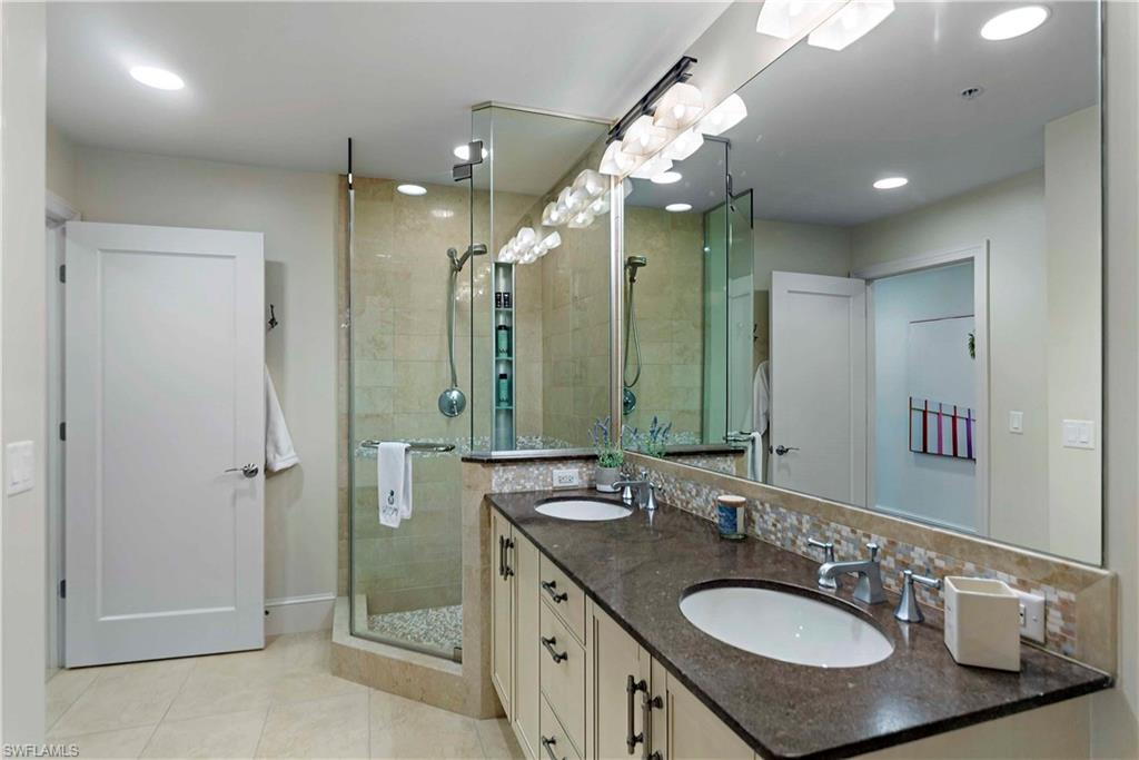 9115 Strada Place, Unit 5501 Naples, FL 34108 - Photo 15 of 31 a bathroom with a sink double vanity and a mirror
