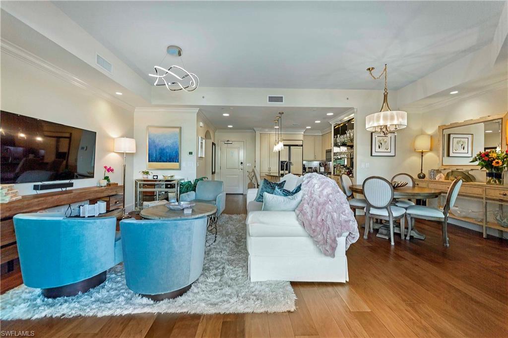 9115 Strada Place, Unit 5501 Naples, FL 34108 - Photo 2 of 31 a living room with furniture and a flat screen tv