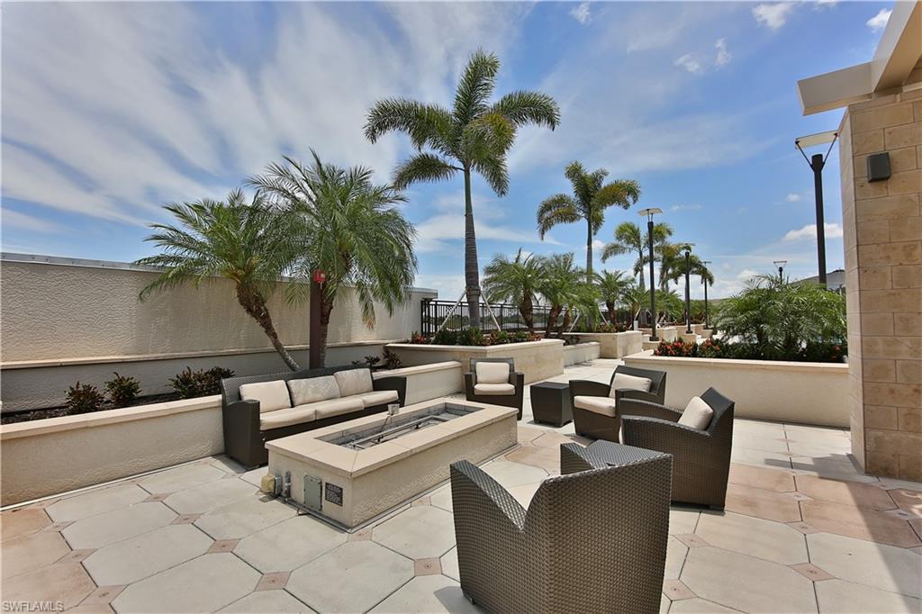 9115 Strada Place, Unit 5501 Naples, FL 34108 - Photo 21 of 31 a view of a patio with couches and potted plants