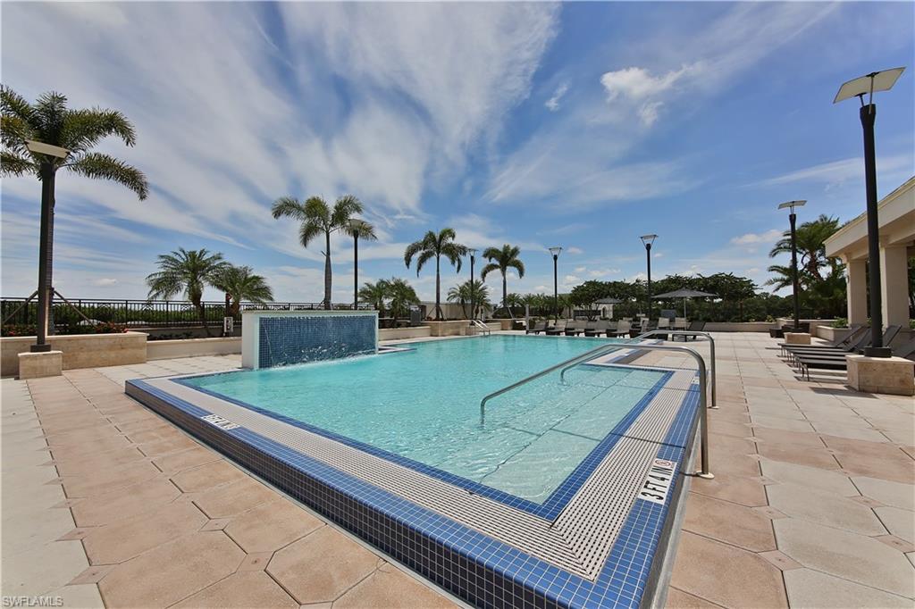 9115 Strada Place, Unit 5501 Naples, FL 34108 - Photo 24 of 31 a view of a swimming pool with a lounge chairs