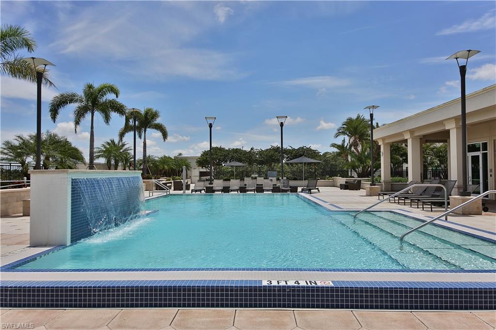9115 Strada Place, Unit 5501 Naples, FL 34108 - Photo 25 of 31 a view of a swimming pool with a table and chairs