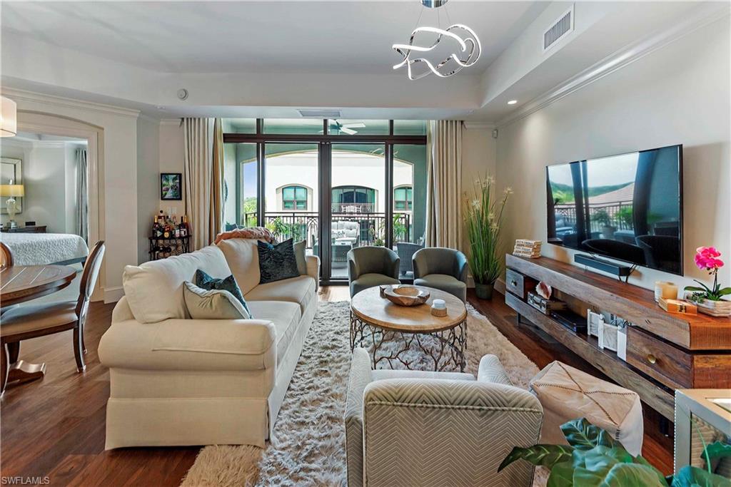 9115 Strada Place, Unit 5501 Naples, FL 34108 - Photo 5 of 31 a living room with furniture and a flat screen tv