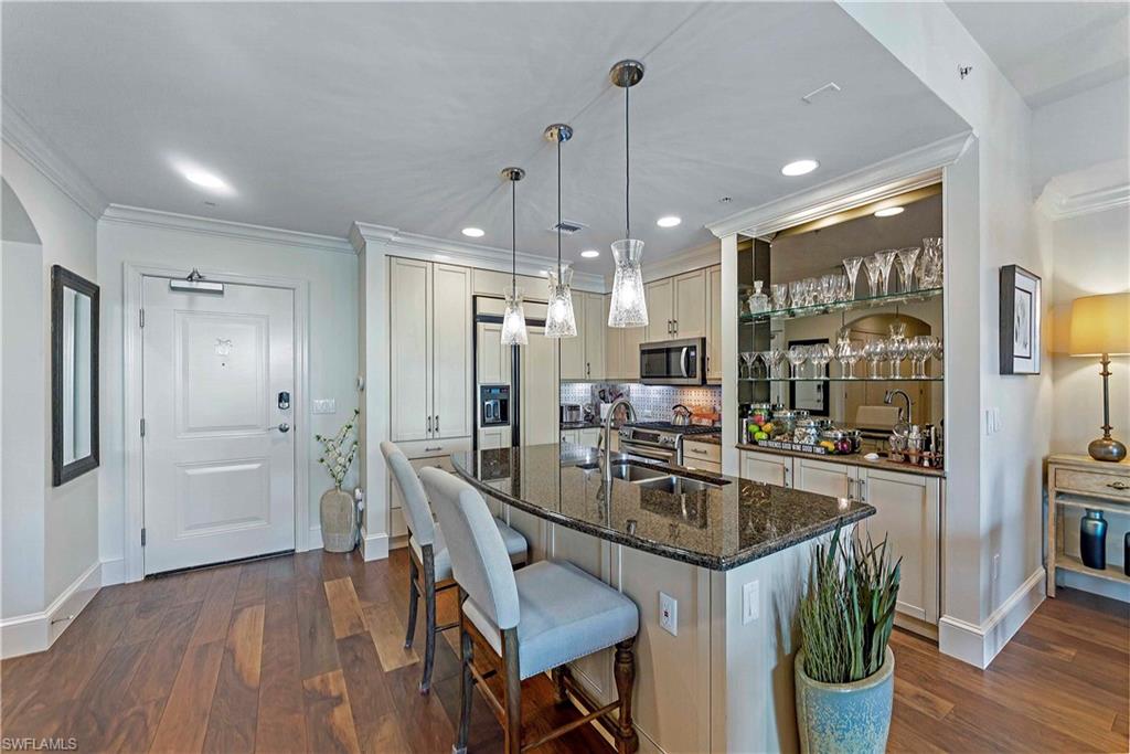 9115 Strada Place, Unit 5501 Naples, FL 34108 - Photo 6 of 31 a kitchen with a table and chairs