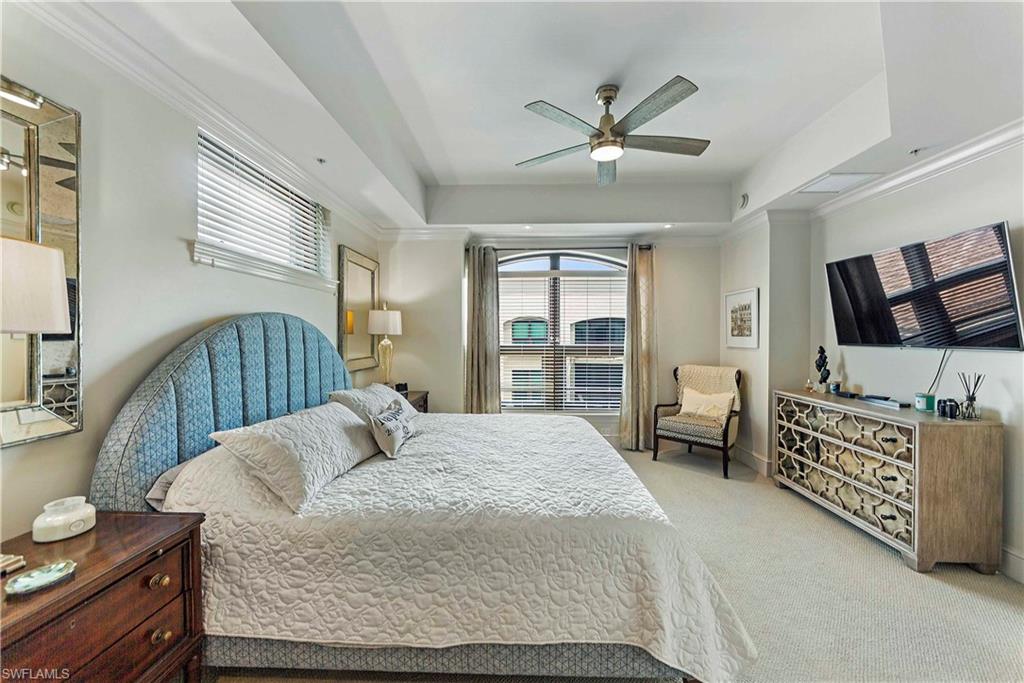 9115 Strada Place, Unit 5501 Naples, FL 34108 - Photo 10 of 31 a bedroom with a bed and wooden floor