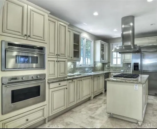a kitchen with stainless steel appliances granite countertop a stove and cabinets