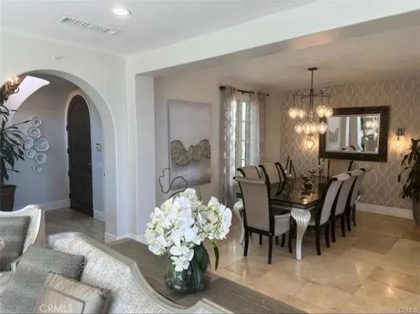 a view of a dining room with furniture and chandelier