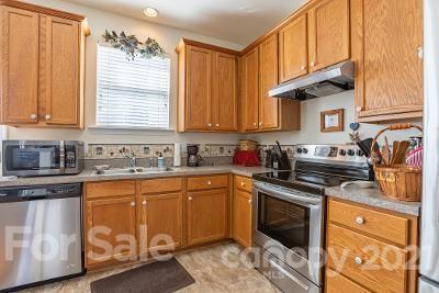 923 Azurine Circle Fort Mill, SC 29708 - Photo 13 of 32 a kitchen with stainless steel appliances granite countertop a sink stove and cabinets