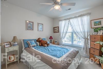 923 Azurine Circle Fort Mill, SC 29708 - Photo 15 of 32 a bedroom with a bed a large window with table and chair