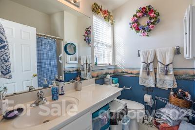 923 Azurine Circle Fort Mill, SC 29708 - Photo 17 of 32 a bathroom with a sink mirror and toilet