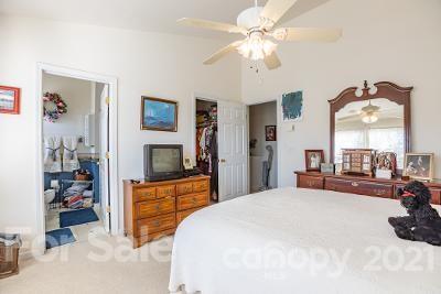 923 Azurine Circle Fort Mill, SC 29708 - Photo 23 of 32 a bedroom with a bed and a large mirror with a flat tv screen