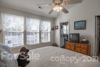 923 Azurine Circle Fort Mill, SC 29708 - Photo 24 of 32 a bedroom with a bed and a flat tv screen on the dresser next to a window